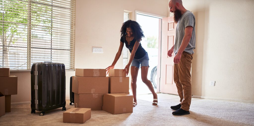 interracial couple moving into new house with boxes